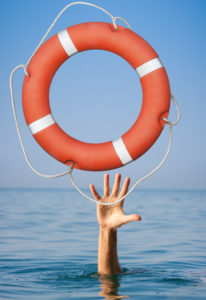 Lifebuoy for drowning man's hand in open sea or ocean water.